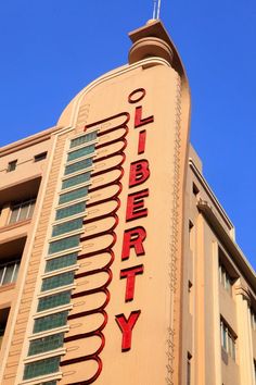 a tall building with the word liberty on it's side in front of a blue sky