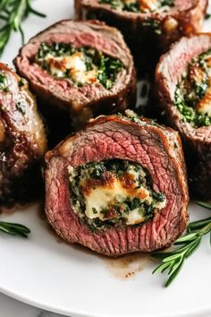 steaks with spinach and cheese on a white plate, ready to be eaten