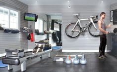 a man standing next to a bike in a garage