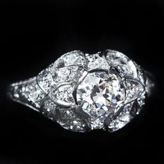 an old - fashioned diamond ring is shown on a black background