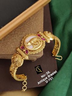 Description :- Antique gold plated South Indian chain bracelet | Gold Plated Bracelet temple jewelry | Bangle bracelet with matte finish | Indian Designs Gift yourself a royal look with this perfectly crafted kundan necklace set from Manalisstudio. Crafted with high quality kundan stones and pearls, it is impressive in design. The green enamel artwork adds perfect texture to the design. Perfect for weddings and festivities, this antique necklace set should be put on with your favorite sari or le Luxury Temple Jewelry Bracelets For Puja, Gold Metal Temple Jewelry Bracelets, Gold Metal Temple Jewelry Bracelet, Temple Jewelry Style Brass Bracelets As Gift, Temple Jewelry Brass Bracelets As Gift, Brass Temple Jewelry Bracelets As Gift, Gold Matte Finish Jewelry Gift, Matte Finish Gold Jewelry Gift, Temple Bracelet