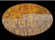 a round wooden table with black background