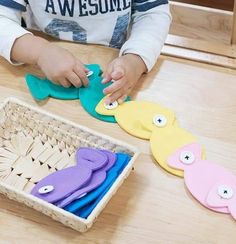 a young child playing with paper cut outs