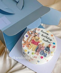 a winnie the pooh birthday cake in a box