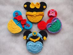 crocheted mickey mouse slippers and other items are arranged on a white surface