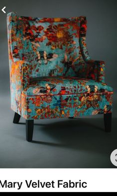 the mary velvet fabric chair is upholstered with colorful flowers and has black legs