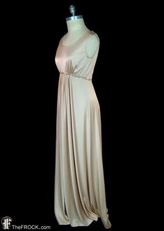 "BIG NEWS After 22 years, our website, TheFROCK.com, has had a makeover. Check out the new site, and join our mailing list for new arrivals.  Vintage Halston sleeveless satin-finished jersey goddess gown with center gathered waist and glass beaded waistband. Hidden rear zipper. Bust 36\", waist 28\", length 59\".  Condition is excellent.  Layaway is available. ALL DELIVERY DATES mentioned by Etsy are ESTIMATES, no delivery date or range is guaranteed, though most of our orders arrive ahead of es Stretch Beige Maxi Dress For Evening, Elegant Beige Maxi Dress With Empire Waist, Elegant Beige Empire Waist Maxi Dress, Vintage Halston, Tan Skin Tone, Goddess Gown, Knit Gown, Beaded Maxi Dress, Gown Vintage