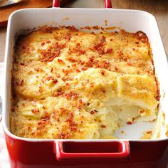 a red casserole dish filled with cheese and meat