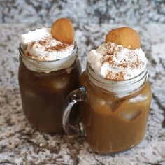 two mason jars filled with hot chocolate and marshmallows