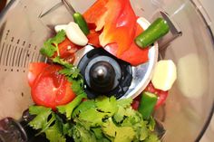 a blender filled with lots of fresh vegetables