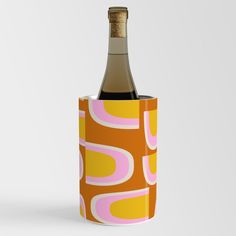 a bottle of wine is wrapped in a paper tube with an orange and pink pattern