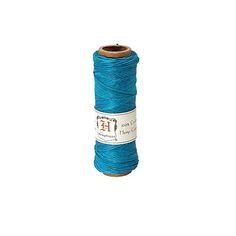 a spool of blue thread on a white background