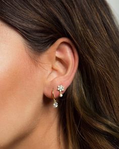 "Small but dazzling, these delicate stud earrings feature shiny flower-shaped zirconia gemstones and a tiny bezel-set CZ drop charm. Look gorgeous worn alone to add some sparkle to your ears and also layer beautifully with other studs and hoops for those with multiple piercings. * D E T A I L S * ∙Sold individually (1 earring) or by pair (2 earrings) ∙ Material: .925 Sterling Silver or 18K Gold Plated over .925 Sterling Silver ∙ Stone: White Zirconia ∙ Dimensions: Flower: 7mm // Total height: 12 Cubic Zirconia Flower-shaped Earrings, Elegant Tiny Silver Huggie Earrings, Elegant White Gold Piercings, White Gold Piercings With Matching Earrings, Delicate Crystal Drop Earrings, Fine Jewelry Cartilage Drop Earrings, Delicate Cubic Zirconia Pierced Earrings, Fine Jewelry Drop Cartilage Earrings, Delicate Cluster Drop Earrings As Gift