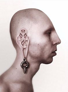 a man's head is shown with an earring on it