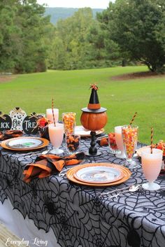 an outdoor table set up for halloween dinner