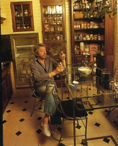 a man sitting at a glass table in a kitchen