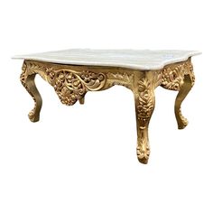 an ornately carved table with marble top and gold leaf decoration on the legs, against a white background