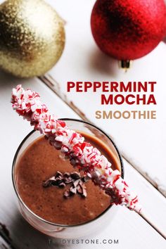 peppermint mocha smoothie in a glass with candy canes