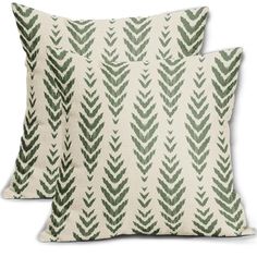 two pillows with green leaves on them