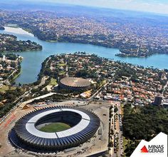 an aerial view of the soccer stadium and surrounding cityscape with water in the background