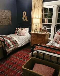 two beds in a room with plaid blankets