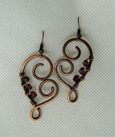 This listing is for one pair wire wrapped Heart Amethyst Crystal in Copper Earrings. Please read all listings carefully and if you have questions, address them to me and I will answer quickly. I thank you for shopping with Sparrow Song. New Pendant by Sparrow Song: Heart Shaped Copper and Crystal Earrings, measures 4.5 by 2.5 cms. Please inquire for your own tailor custom earrings with a choice of metal, crystal or stone. See what my customers are saying about my jewelry https://www.etsy.com/you Wrapping Crystals, Wire Wrapped Heart, Diy Wire Jewelry Rings, Wire Wrap Earrings, Wire Ideas, Wire Jewelry Earrings, Wire Jewelry Patterns, Wire Craft, Wire Wrap Jewelry Designs