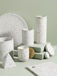 white and black speckled ceramic items on table with plate, napkins, and cups