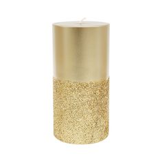 a candle that is sitting in front of a white background with gold flecks