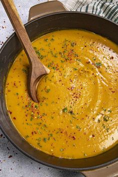 a bowl of soup with a wooden spoon in it