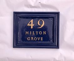 a blue plaque with the number 94 million grove written in gold on it's side