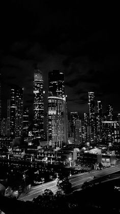 black and white photograph of city skyline at night