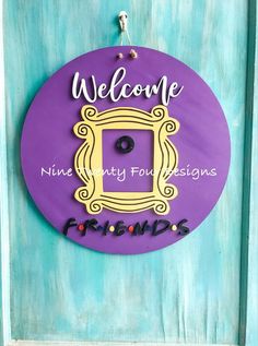 a purple sign that says welcome to friends on it's front door with the word friends painted on it