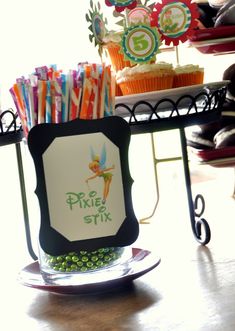 a table topped with lots of cupcakes and candy