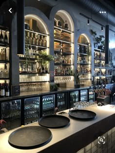 an empty bar with plates on the counter