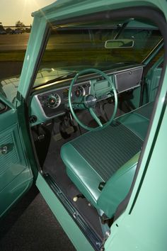 the interior of an old green car with leather seats