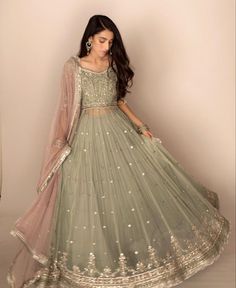 a woman in a green lehenga