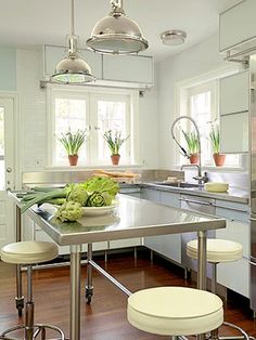 the kitchen is clean and ready to be used for cooking or eating, with stools around the island