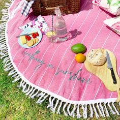 a picnic blanket with food and drinks on it