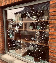 a window decorated with christmas decorations and stars