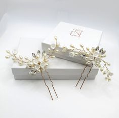 Beautiful and elegant, this delicate hand-wired hair pin is adorn with multiple pearls and mother of pearl carved like flowers. The gold wires are easy to adjust according to your most desired wedding hair style. Sold individually or as a set of 2 identical hairpins. Hand wired branches of tender spring blossoms create a semi-floating effect when placed into the hair.DETAILS:Hand wired with resin petals and pearls.Sold individually or as a set of 2 hairpins (identical design)Measures about 3.0"L Resin Petals, Pearl Bridesmaid Jewelry, Pearl Bridal Hair, Bridal Hair Pins Pearl, Hair Details, Beach Jewelry Boho, Gold Hair Pin, Spring Blossoms, Wire Flowers