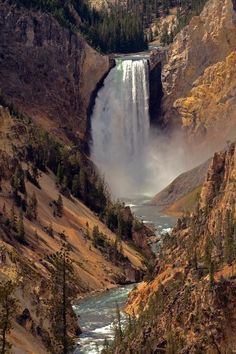 a waterfall in the middle of a canyon