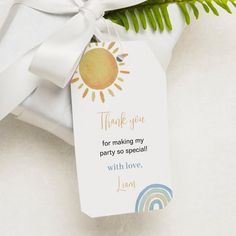 a thank you tag attached to a white gift bag