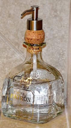 a soap dispenser sitting on top of a counter next to a wall