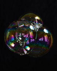 three soap bubbles floating on top of each other