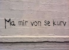 graffiti written on the side of a white brick wall that reads ma mirr von se kur