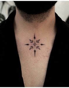 a black and white photo of a man's neck with a star tattoo on it