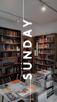 a library filled with lots of books next to a white table