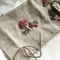 a piece of cloth with embroidered mushrooms on it