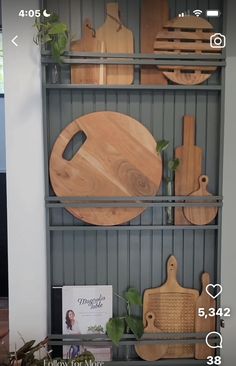 a shelf with cutting boards and other kitchen utensils