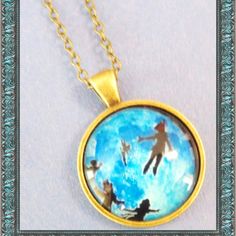 an image of people swimming in the water on a gold plated necklace with chain